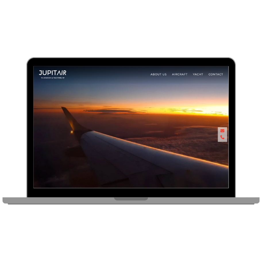 Laptop mockup displaying Jupitair Aviation & Yachting homepage, featuring an aerial view of an aircraft wing at sunset above the clouds with a navigation menu including About Us, Aircraft, Yacht, and Contact.