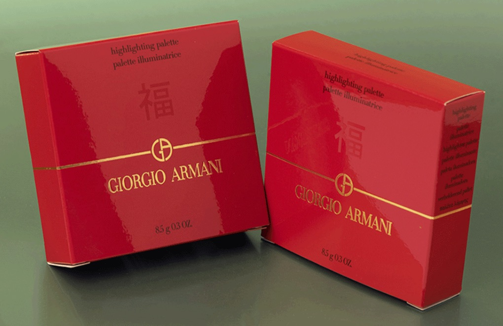 Red Giorgio Armani packaging on a green background 