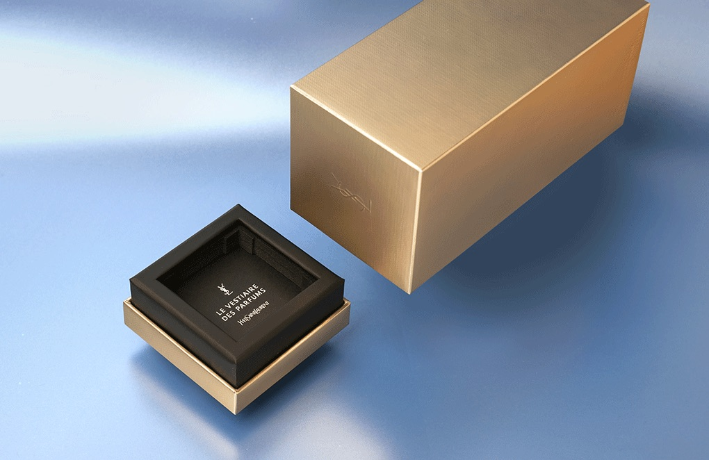 YSL packaging in gold on a blue background 